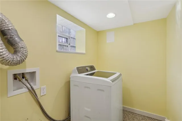 a utility room with a sink dryer and washer