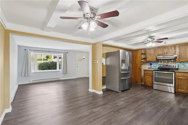 a kitchen with stainless steel appliances granite countertop a refrigerator and a stove top oven