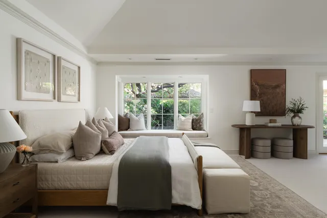 a spacious bathroom with a tub sink and mirror