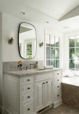 a view of bedroom with window and cabinet