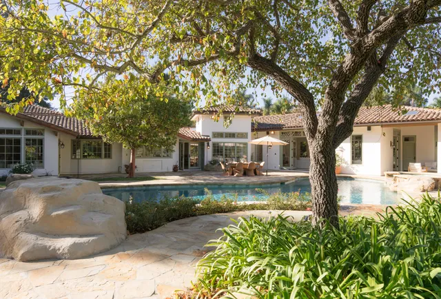 an aerial view of a house with a swimming pool