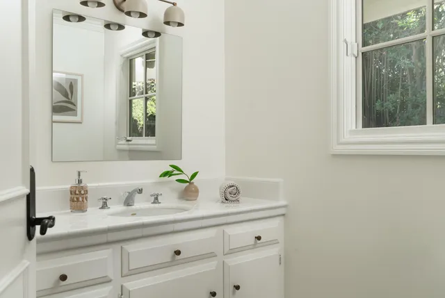 a living room with furniture a flat screen tv and a floor to ceiling window