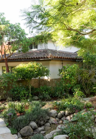 a backyard of a house with a tree