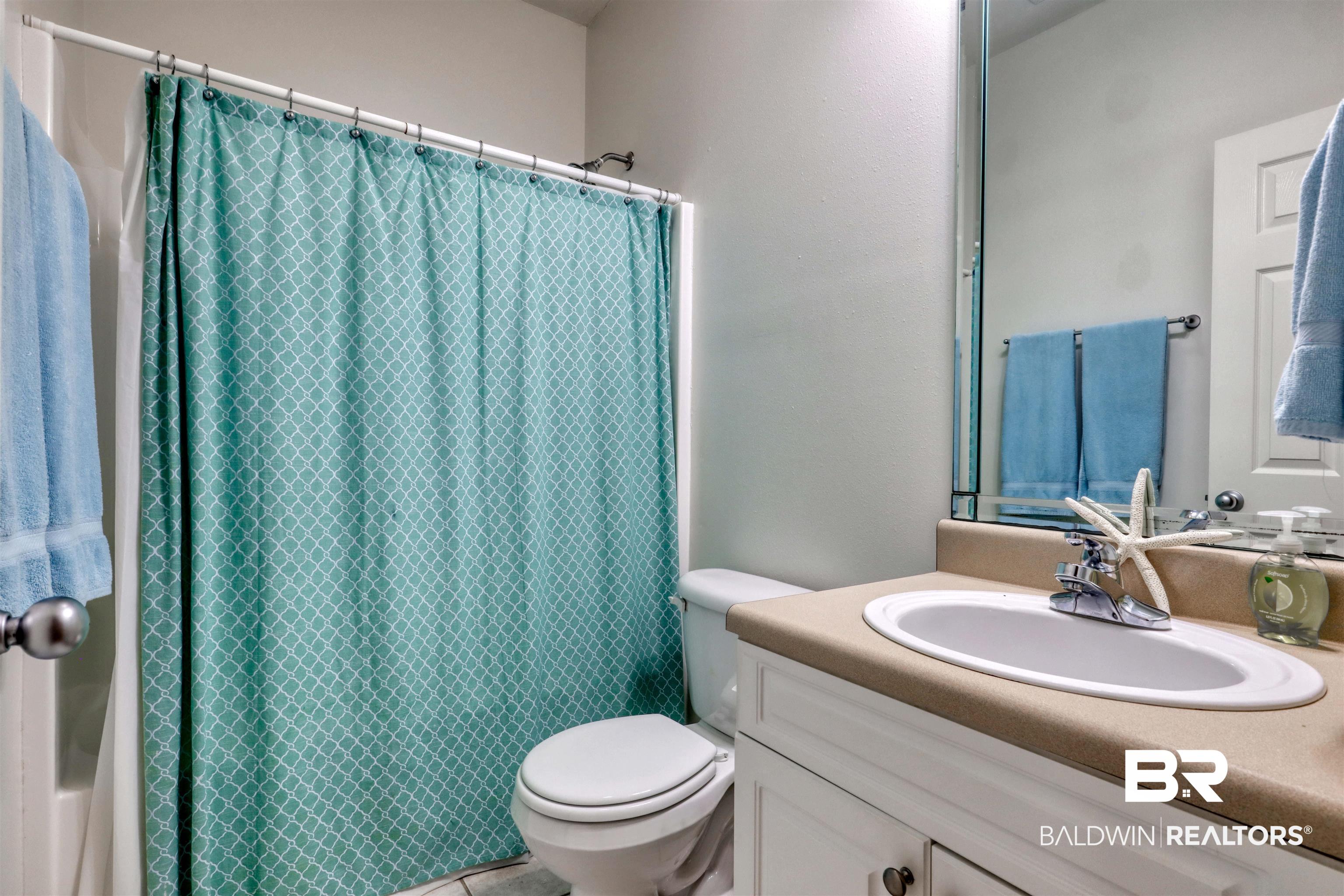 26063 Canal Road, Unit C2 Orange Beach, AL 36561 - Photo 17 of 30 Full bath featuring vanity and toilet