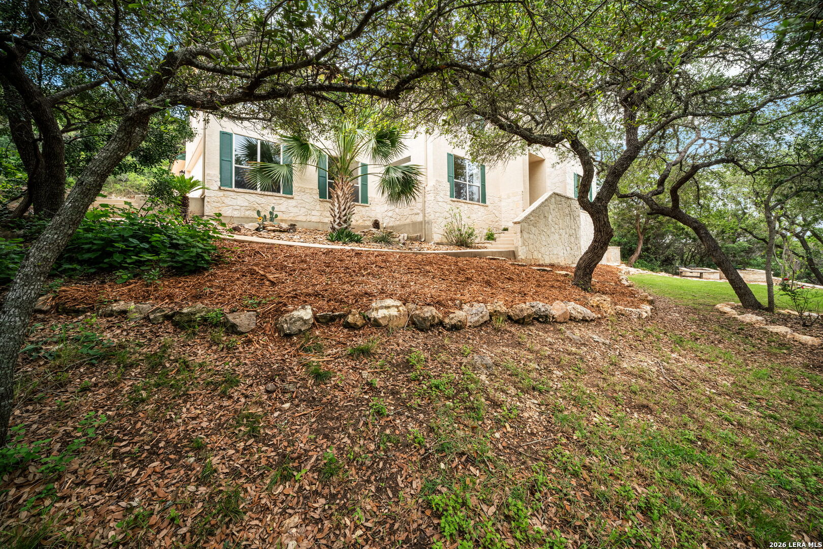 17431 Helotes Spring Road Helotes, TX 78023 - Photo 2 of 50 a front view of a house with a yard