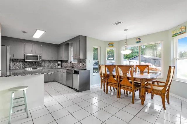 a bathroom with a double vanity sink mirror and bathtub