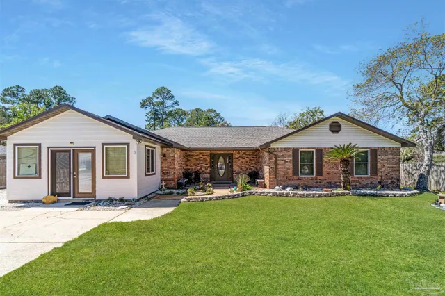 a front view of house with yard and green space