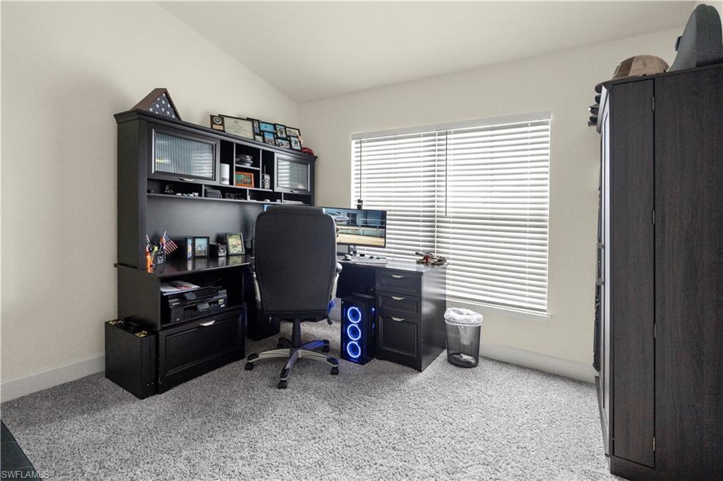 2512 20th Street Southwest Lehigh Acres, FL 33976 - Photo 12 of 48 a view of a workspace with furniture and a window