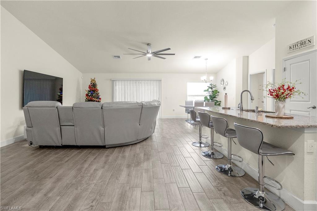 2512 20th Street Southwest Lehigh Acres, FL 33976 - Photo 15 of 48 a living room with furniture and a wooden floor
