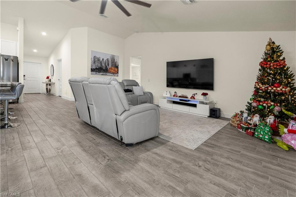 2512 20th Street Southwest Lehigh Acres, FL 33976 - Photo 16 of 48 a living room with furniture and a flat screen tv