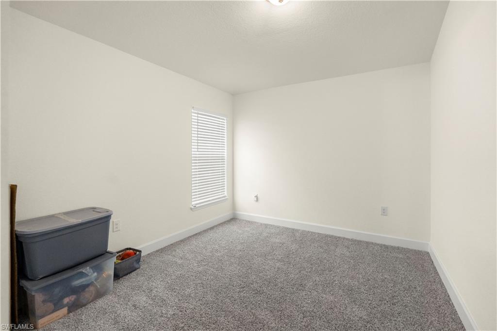 2512 20th Street Southwest Lehigh Acres, FL 33976 - Photo 24 of 48 a room with a window