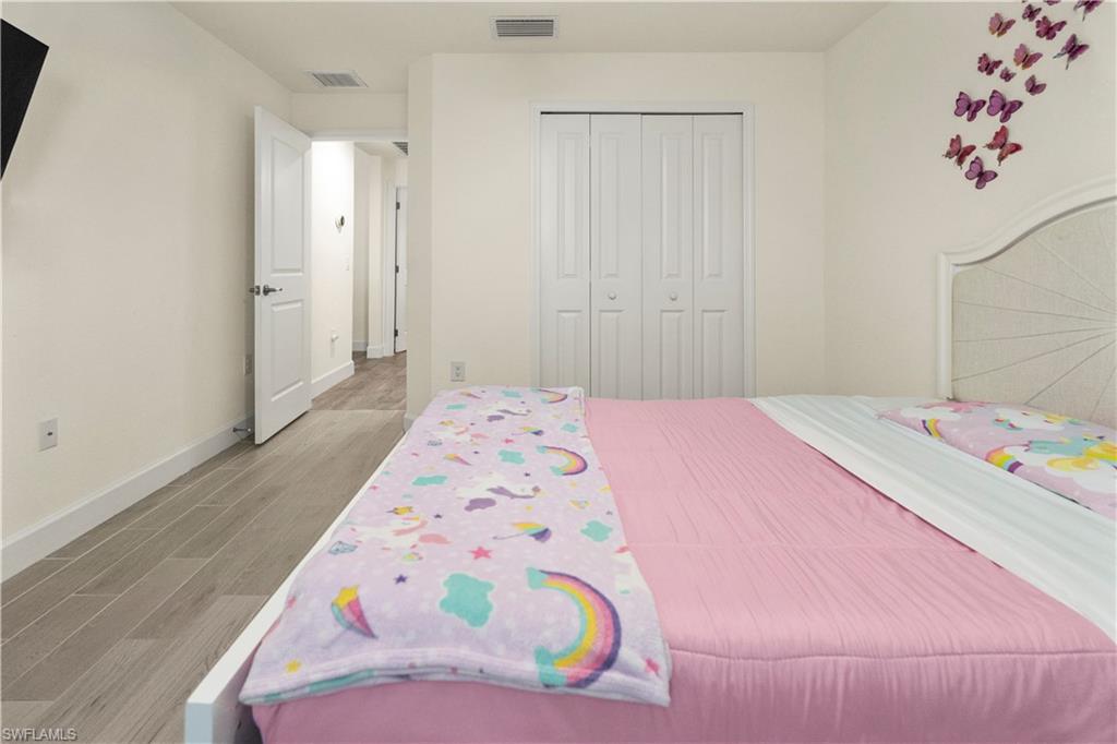 2512 20th Street Southwest Lehigh Acres, FL 33976 - Photo 28 of 48 a bedroom with a bed and a dresser