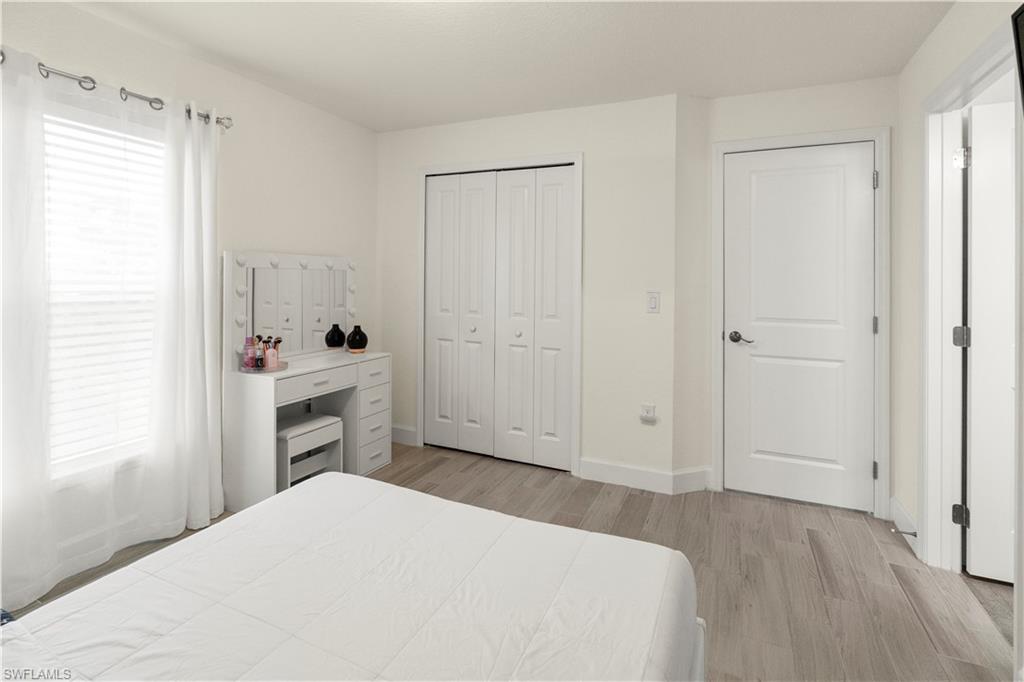 2512 20th Street Southwest Lehigh Acres, FL 33976 - Photo 29 of 48 a bedroom with a bed and a closet