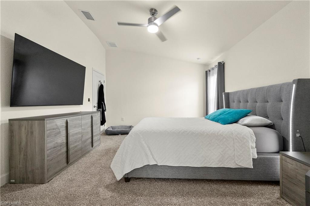 2512 20th Street Southwest Lehigh Acres, FL 33976 - Photo 32 of 48 a bedroom with a bed and a flat screen tv