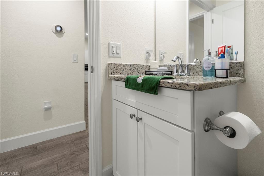 2512 20th Street Southwest Lehigh Acres, FL 33976 - Photo 38 of 48 a bathroom with a granite countertop sink and a mirror