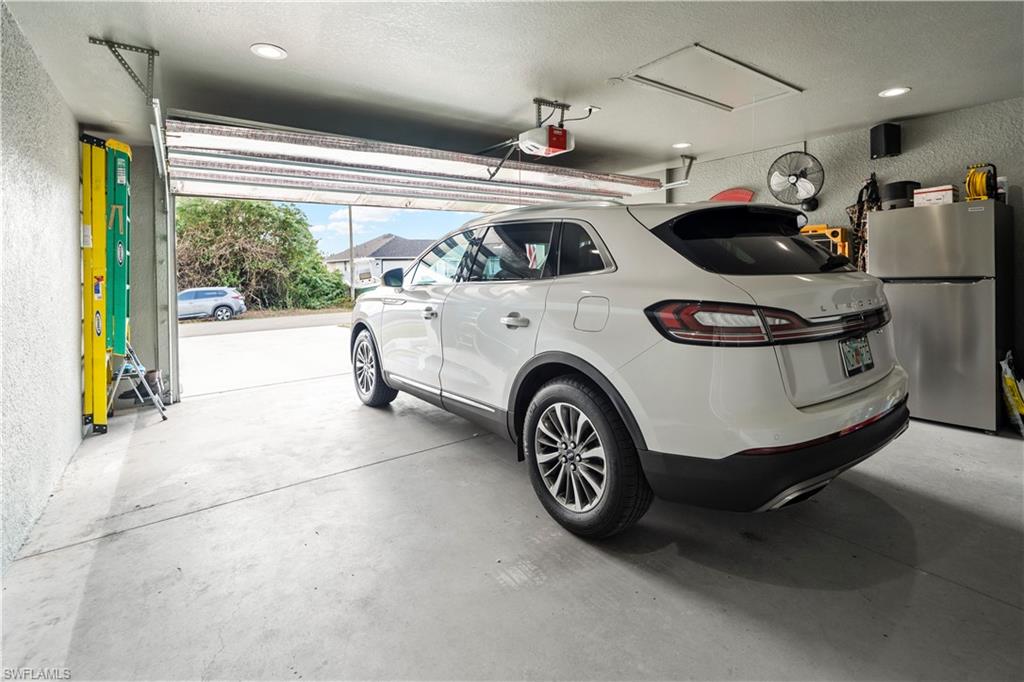 2512 20th Street Southwest Lehigh Acres, FL 33976 - Photo 46 of 48 a car and bike parked in a parking garage