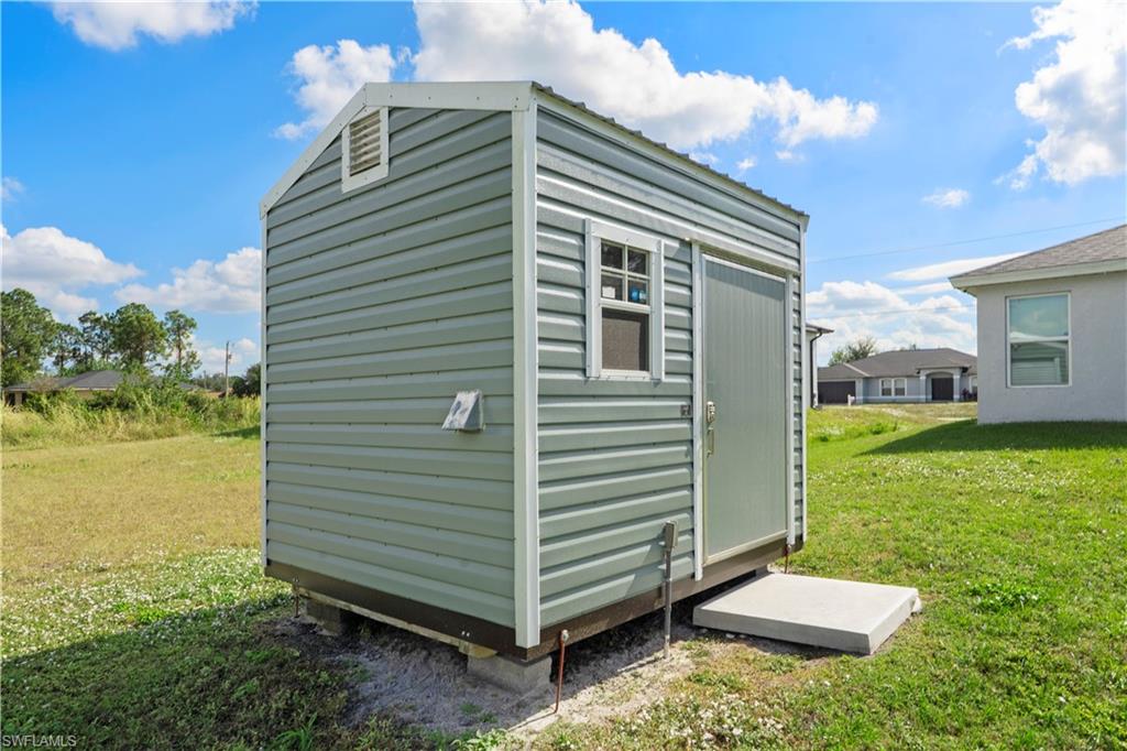 2512 20th Street Southwest Lehigh Acres, FL 33976 - Photo 47 of 48 a view of backyard with barbeque grill and potted plants