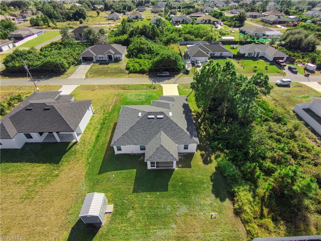 2512 20th Street Southwest Lehigh Acres, FL 33976 - Photo 5 of 48 an aerial view of a house with a garden