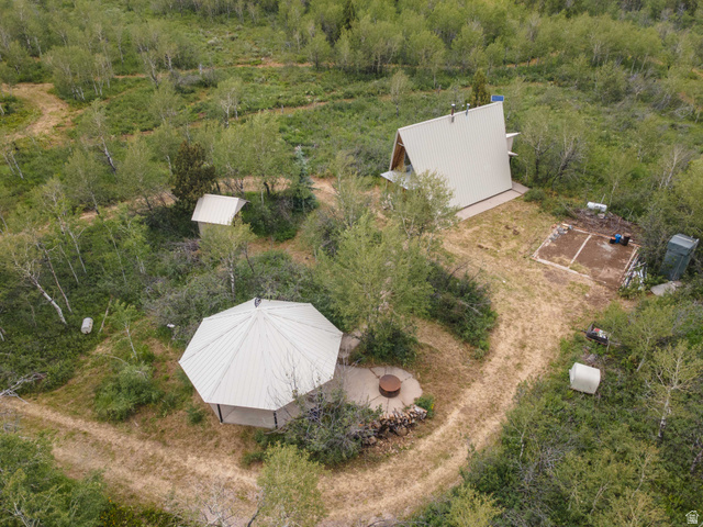 23 Scare Canyon, Unit 23 Logan, UT 84321 - Photo 29 of 33 Aerial overview highlighting an A-frame structure with a metal roof, surrounded by extensive natural foliage