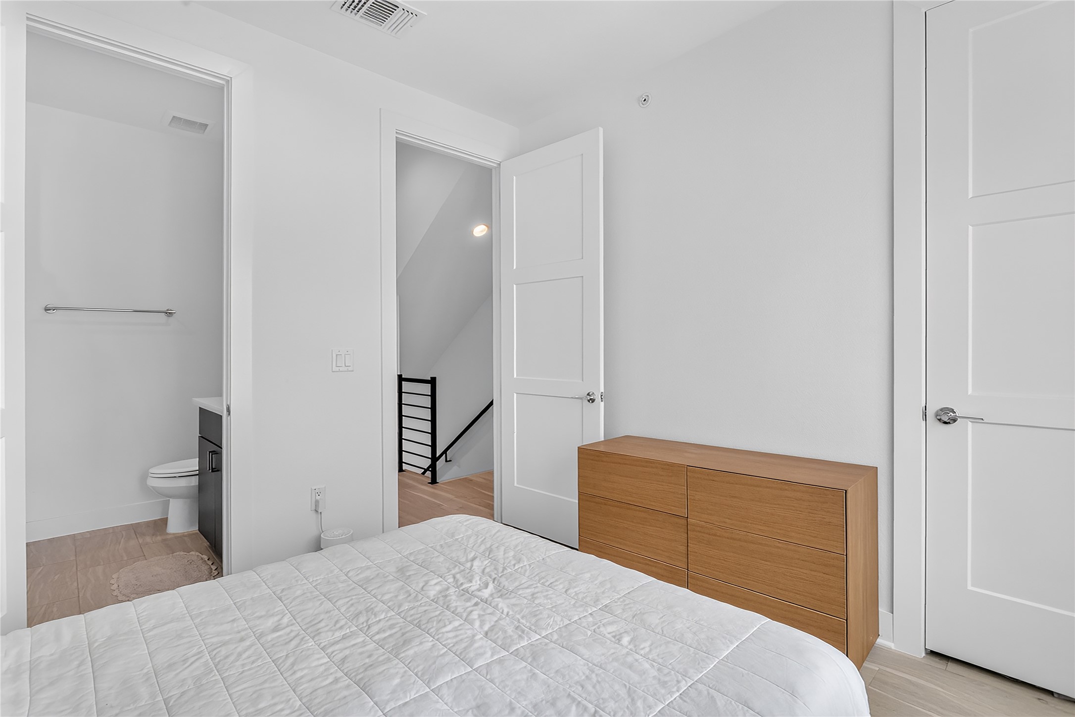 2805 McCurdy Street, Unit 14 Austin, TX 78723 - Photo 19 of 40 Well-lit sleeping quarters with a dedicated adjacent bathroom and convenient access to stairs.
