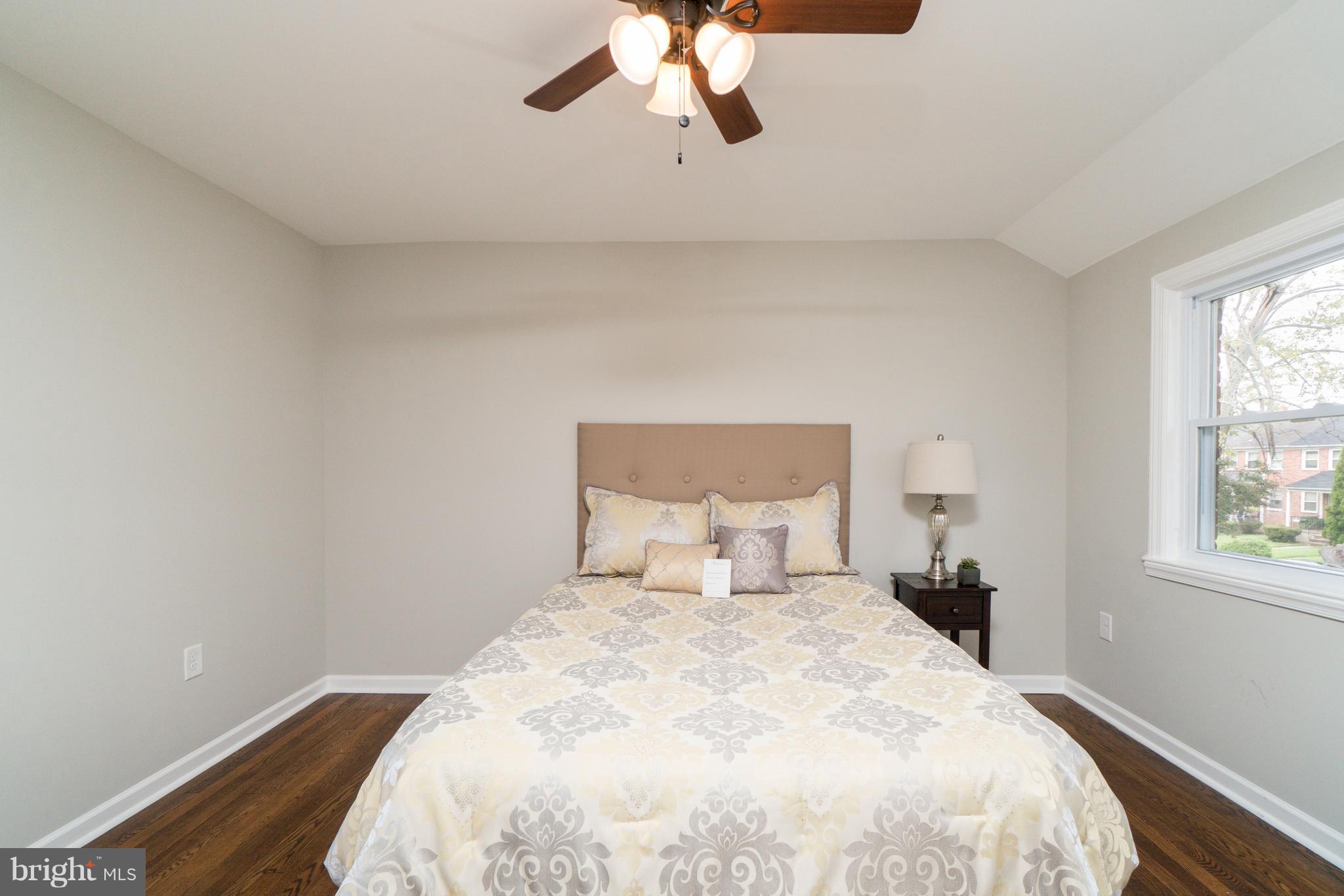 1419 Stonewood Road Baltimore, MD 21239 - Photo 13 of 28 Spacious Bedroom With Ceiling Fan & Hardwood Floor