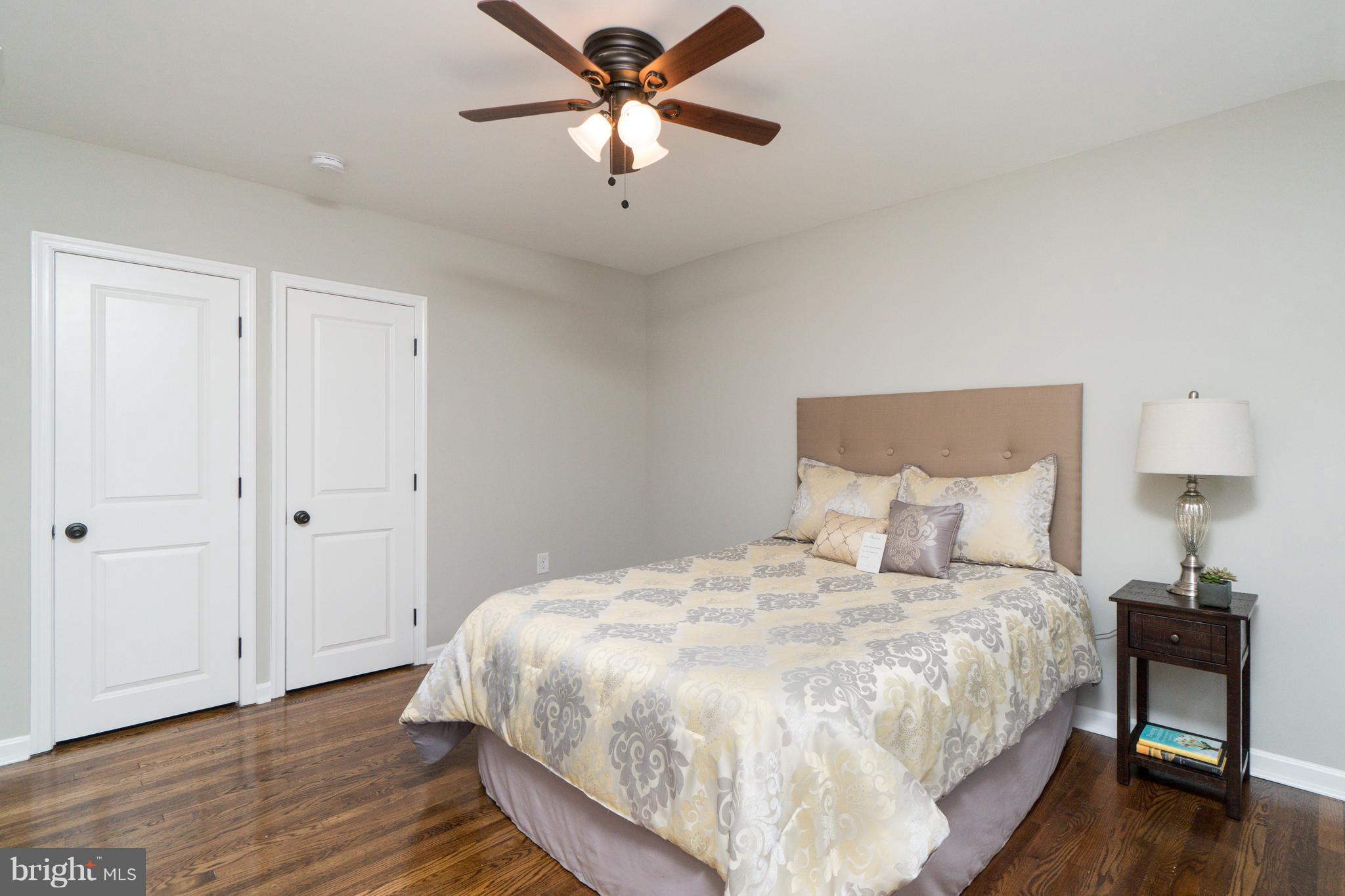 1419 Stonewood Road Baltimore, MD 21239 - Photo 14 of 28 Spacious Bedroom With Ceiling Fan & Hardwood Floor