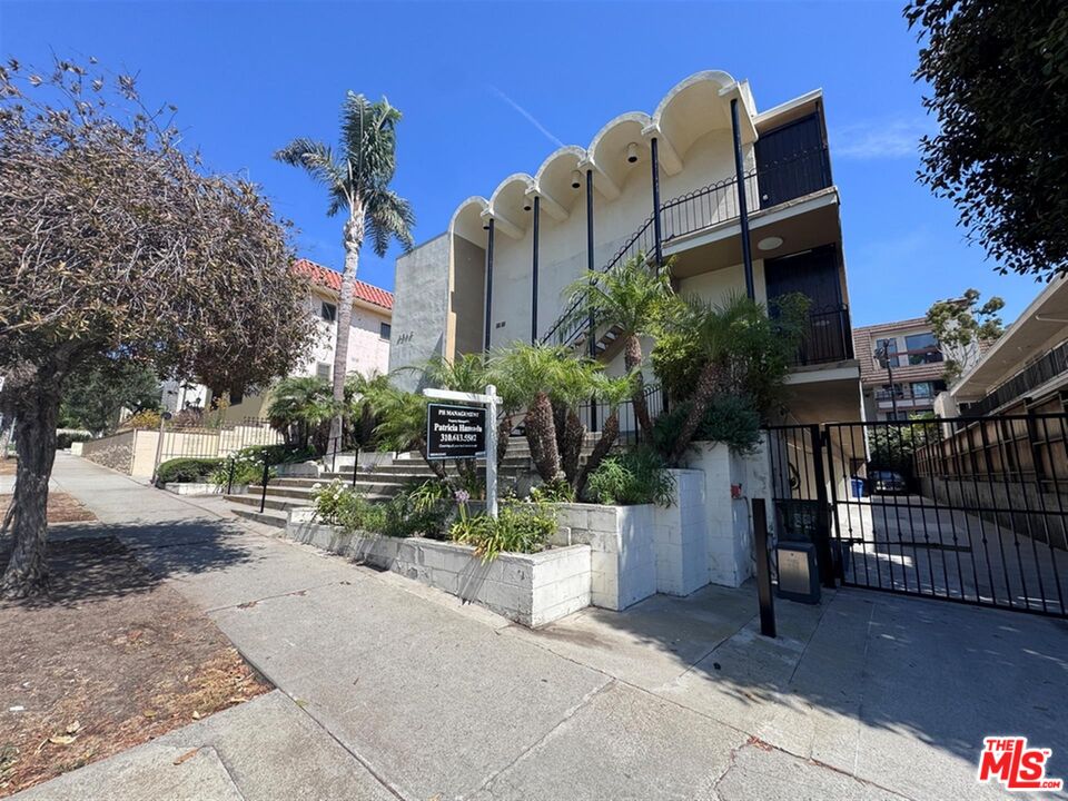 8346 Manitoba Street, Unit 11 Playa del Rey, CA 90293 - Photo 3 of 14 a view of a house with a yard and potted plants