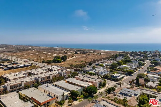 an aerial view of a city with ocean view