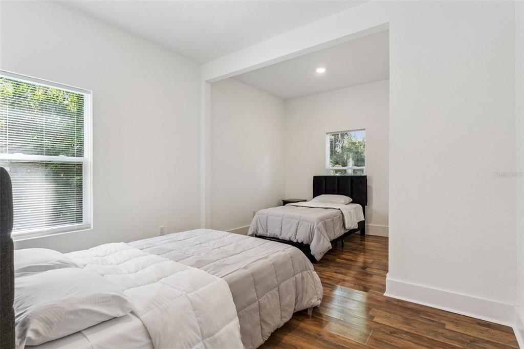 145 Ruth Avenue Cocoa, FL 32922 - Photo 13 of 23 a bedroom with two beds and wooden floor