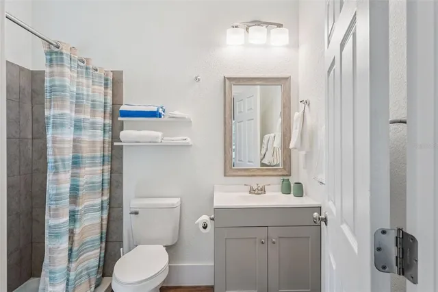 a bedroom with a bed and a lamp on desk