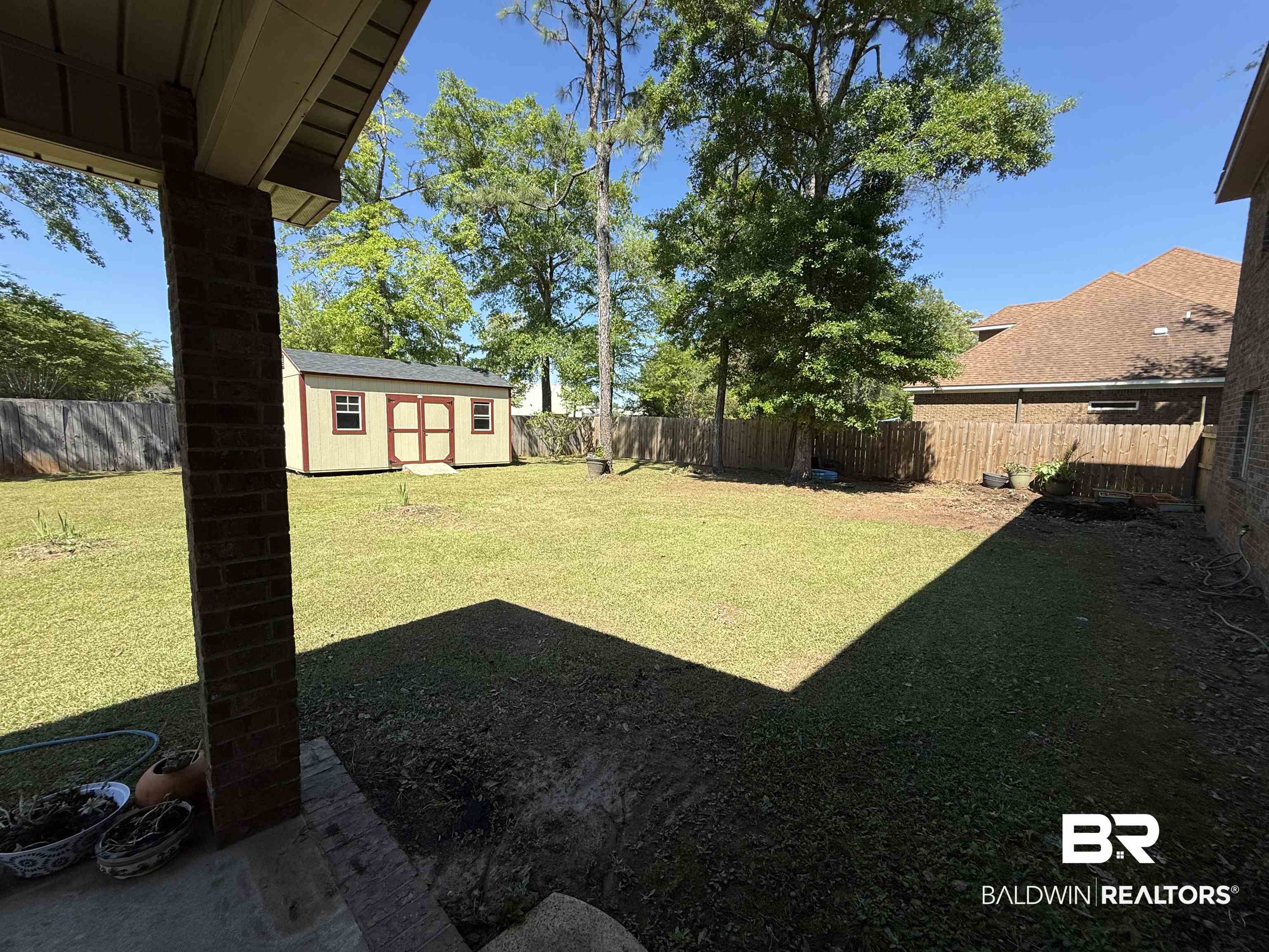 9023 Krystal Ridge Court Daphne, AL 36526 - Photo 33 of 41 Fenced backyard featuring a storage shed and a patio
