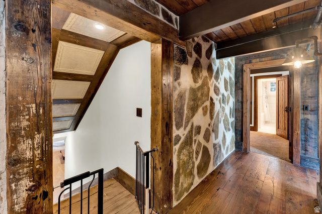 2983 East Ridgetop Road, Unit 27 Provo, UT 84604 - Photo 46 of 63 Rustic-modern interior featuring exposed timber beams, stone accent walls, and hardwood flooring throughout