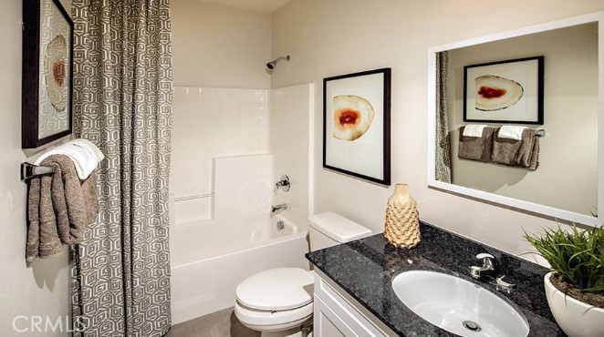 14080 Versimo Lane Beaumont, CA 92223 - Photo 11 of 20 a bathroom with a granite countertop sink mirror vanity and toilet