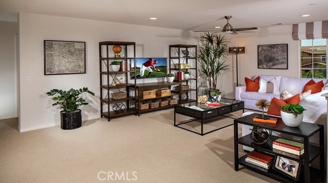 14080 Versimo Lane Beaumont, CA 92223 - Photo 12 of 20 a living room with furniture potted plant and kitchen view