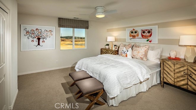 14080 Versimo Lane Beaumont, CA 92223 - Photo 16 of 20 a bedroom with a bed and a painting on the wall