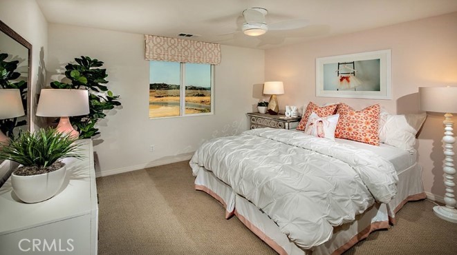 14080 Versimo Lane Beaumont, CA 92223 - Photo 17 of 20 a spacious bedroom with a bed and a potted plant