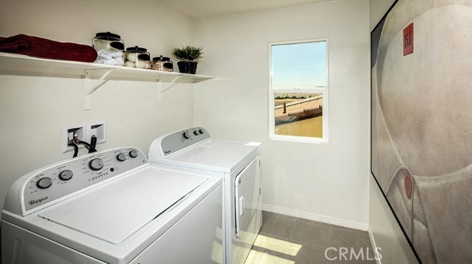 14080 Versimo Lane Beaumont, CA 92223 - Photo 20 of 20 a utility room with dryer and washer