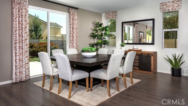 14080 Versimo Lane Beaumont, CA 92223 - Photo 9 of 20 a view of a dining room with furniture and wooden floor