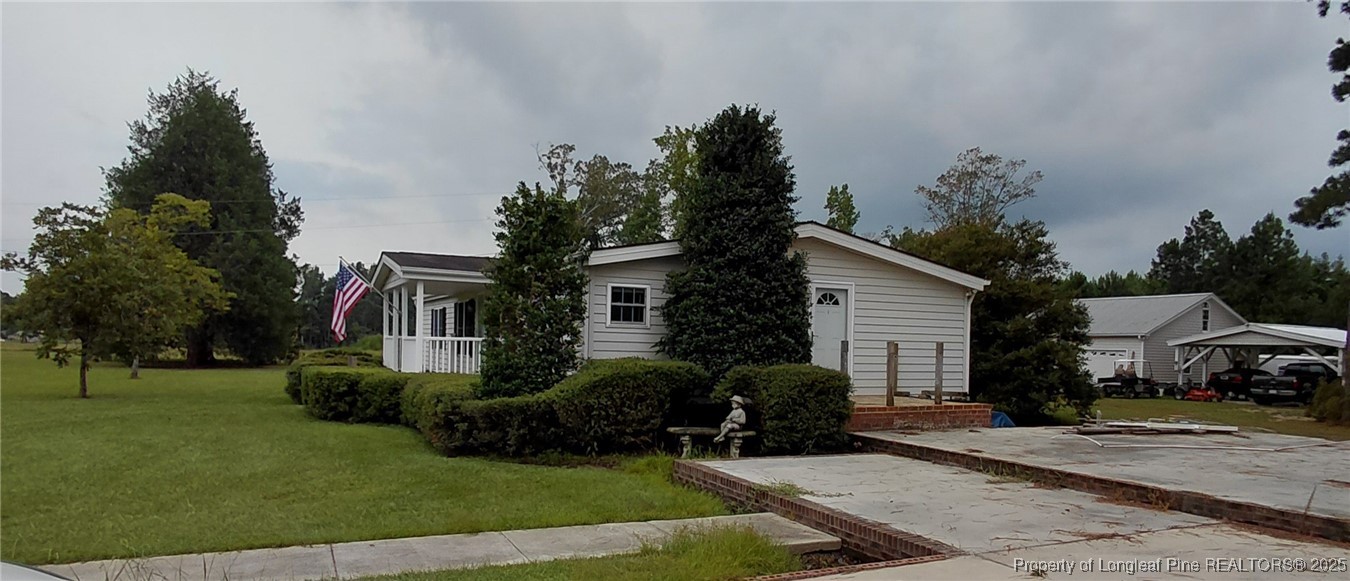 a front view of a house with a garden and trees