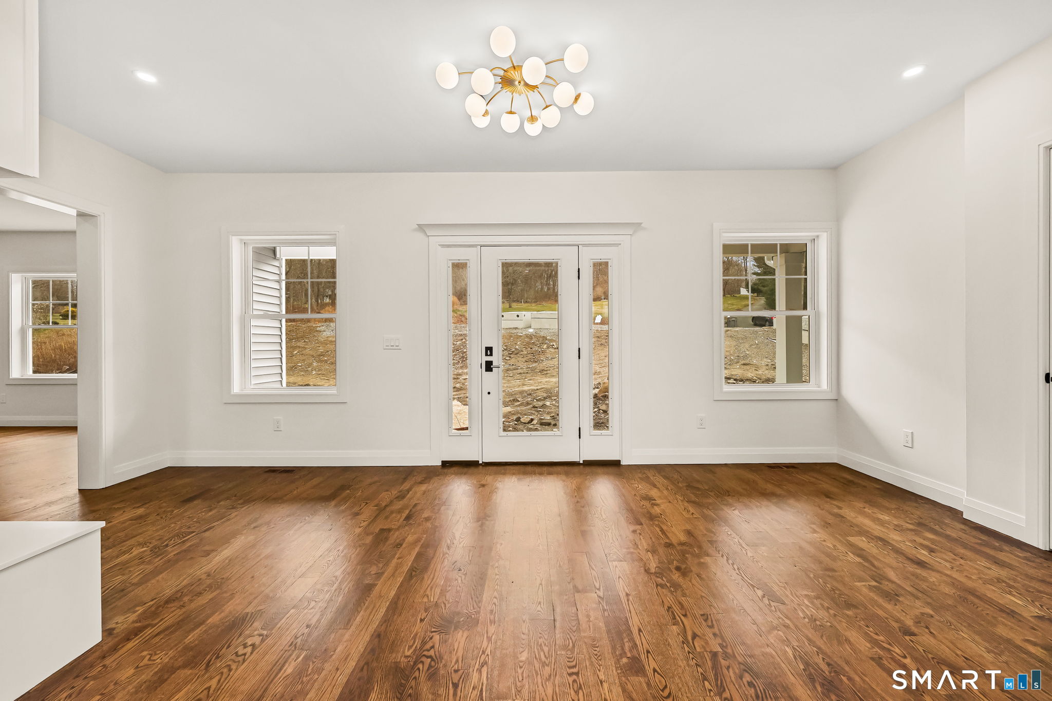 41 Crown View Drive Monroe, CT 06468 - Photo 2 of 41 a view of an empty room with wooden floor and a window