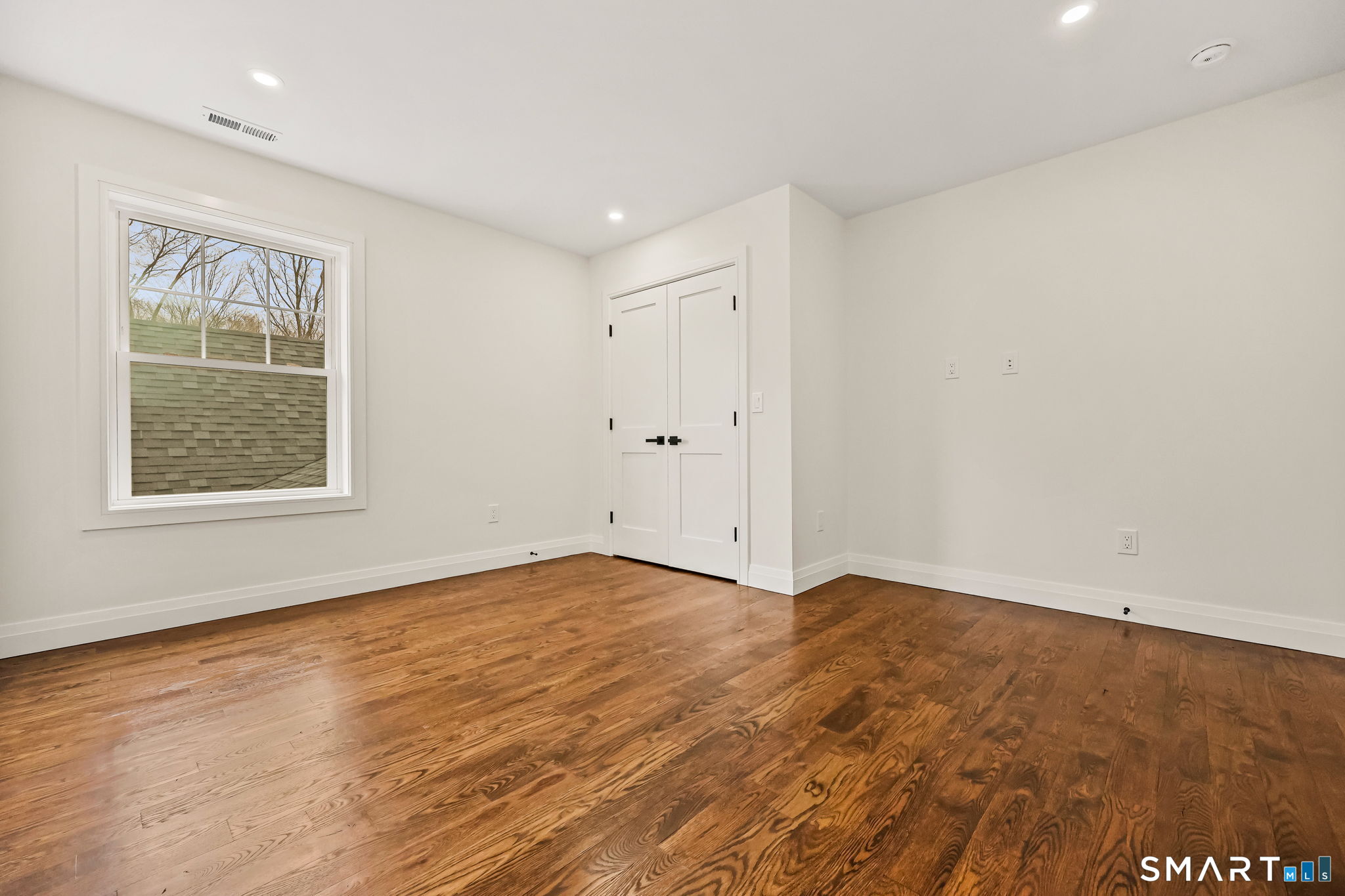 41 Crown View Drive Monroe, CT 06468 - Photo 25 of 41 an empty room with wooden floor and windows