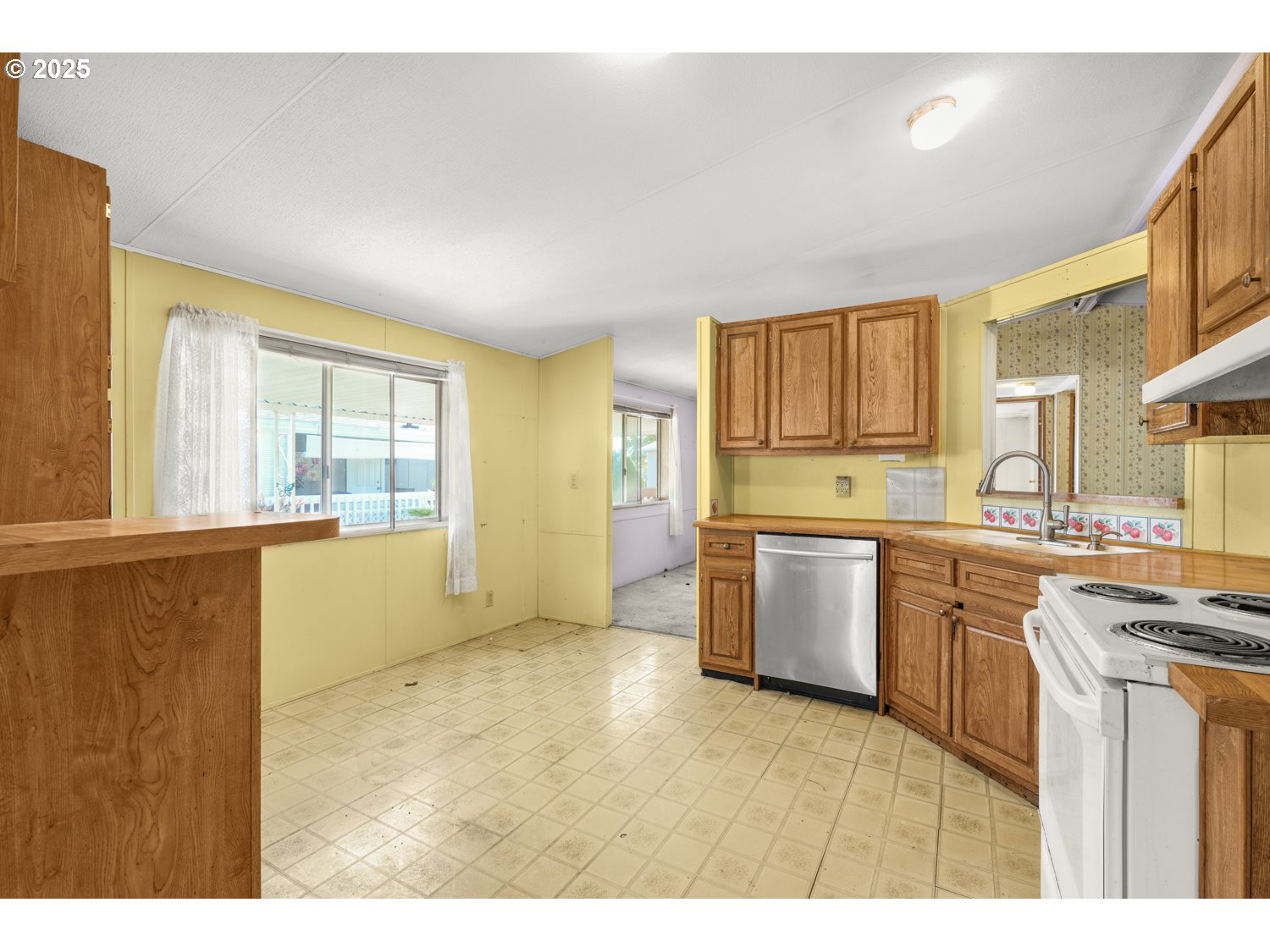 1500 Gabriela Court Northeast, Unit 27 Salem, OR 97301 - Photo 7 of 21 a kitchen with a refrigerator and wooden cabinets