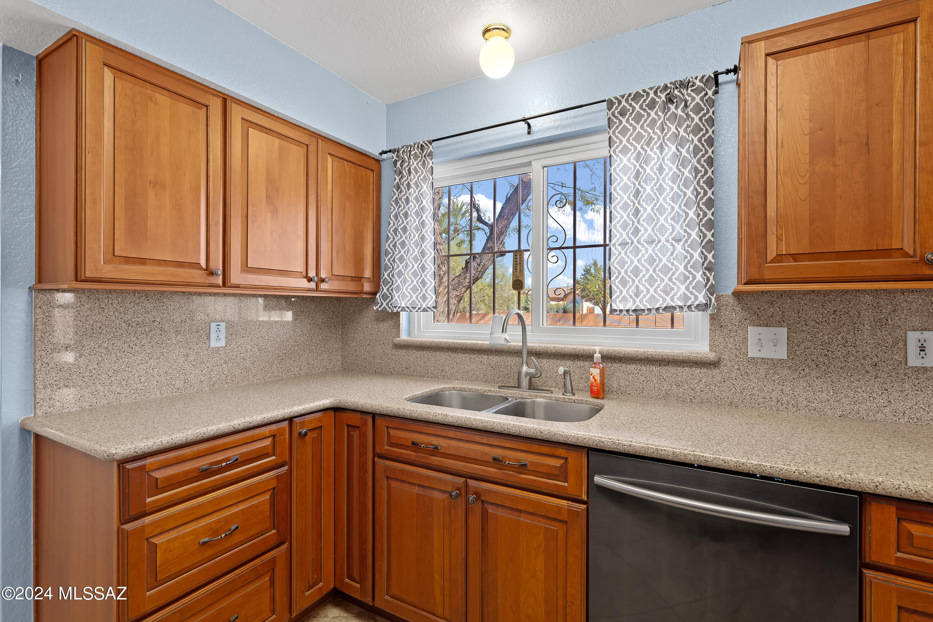 3476 West Sky Ridge Loop Tucson, AZ 85742 - Photo 9 of 31 a kitchen with stainless steel appliances granite countertop a sink and a window