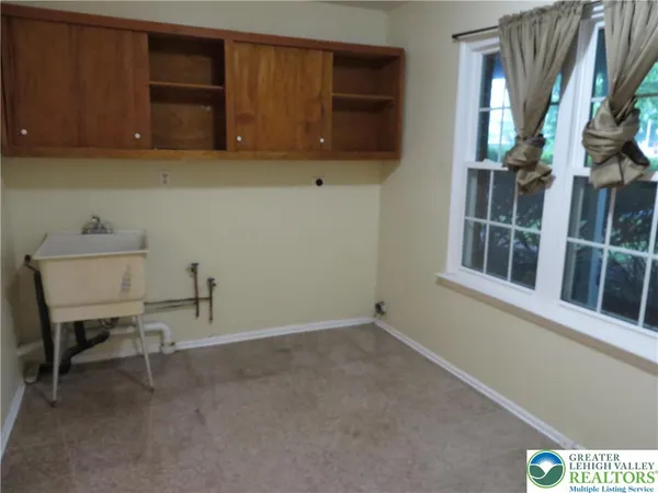 a room with a chair and a window