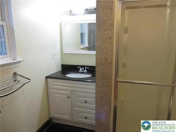 a bathroom with a shower curtain and a sink