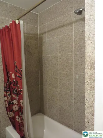 a bathroom with a shower curtain and a sink