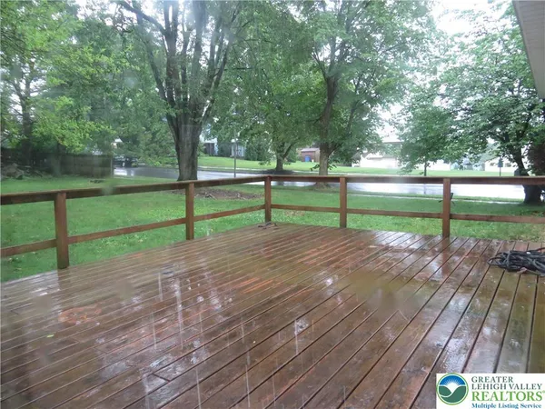 a view of park with wooden floor and fence