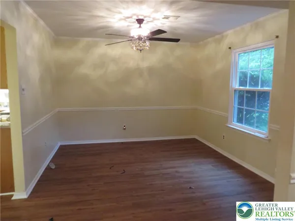 a view of a room with wooden floor and window