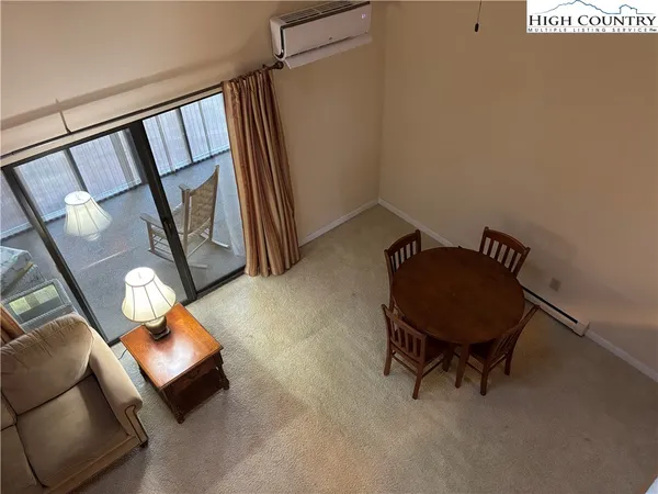 a living room with furniture and a mirror