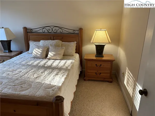 a bed room with a bed and a night stand